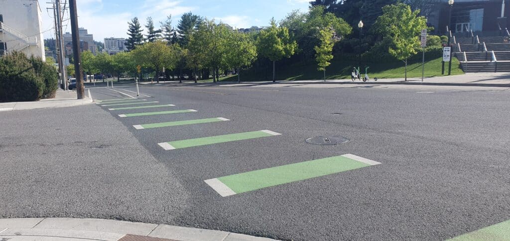 Protected bike lane with plastic bollards on border of bike lane along Howard Street at Joe Albi Way.