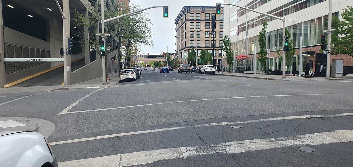 Car and foot fraffic in downtown Spokane near the Wall Street and 1st Avenue intersection.